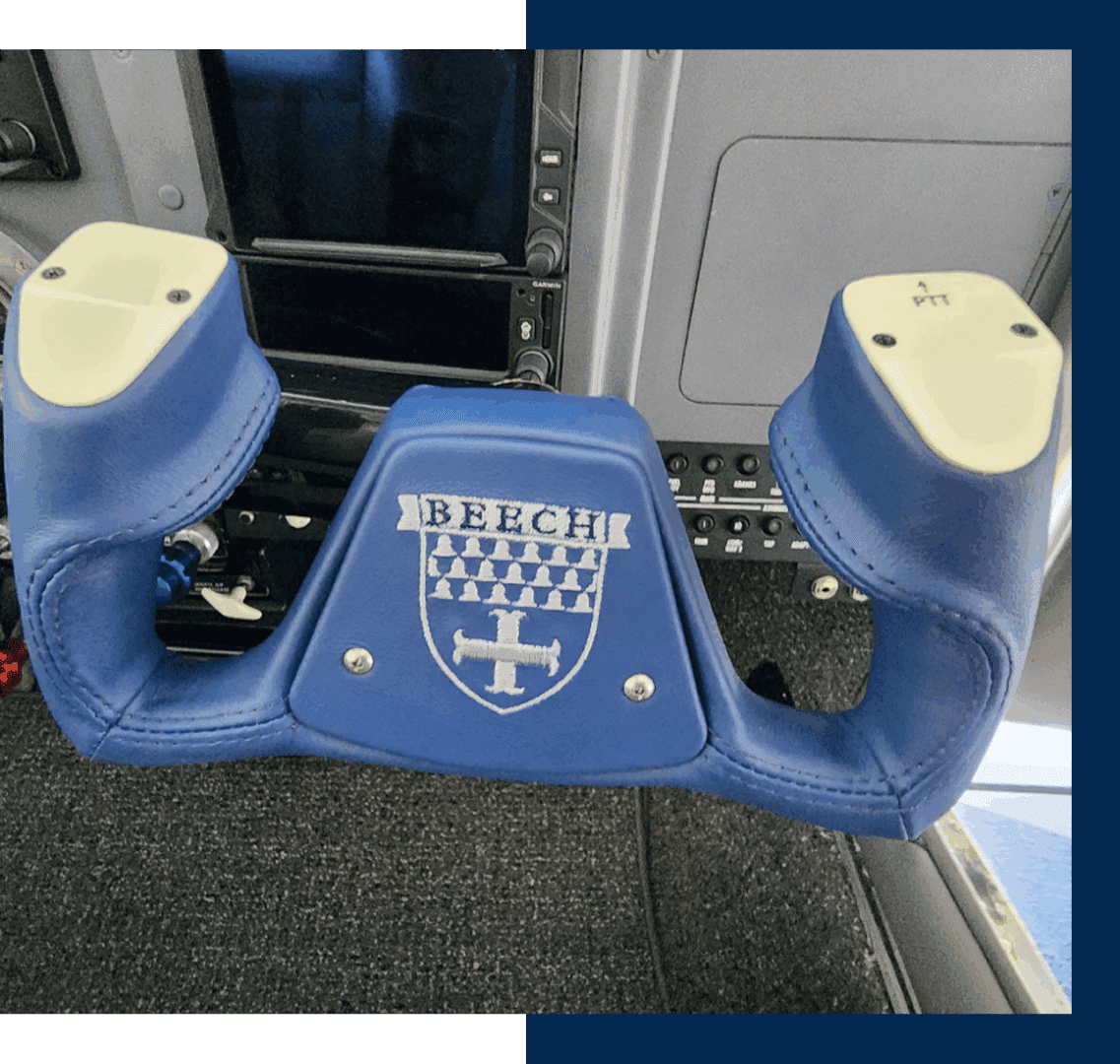 Blue airplane control yoke with Beech logo